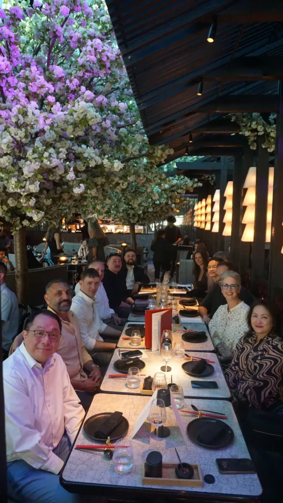 Delegates Sitting Down At Restaurant At