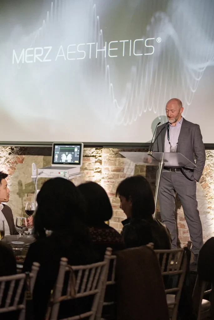 Presenter On Stage At The Merz Aesthetic