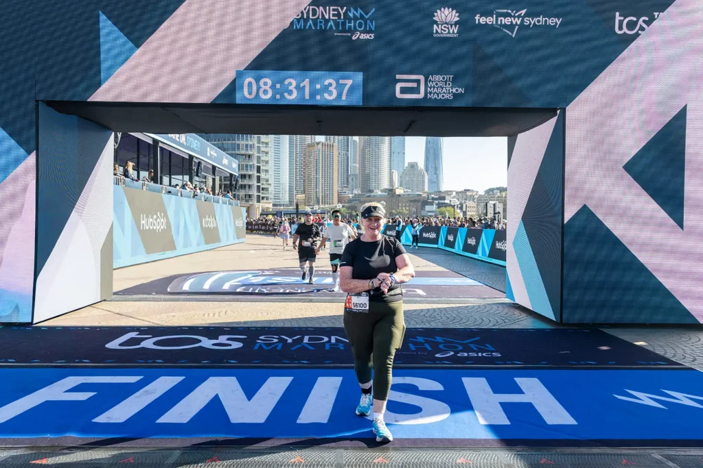 A Runner Crossing the TCS Sydney Marathon Finish Line at Tata Consultancy Services TCS Sydney Marathon 2026, Sydney – Peanut Productions Event Management Case Study